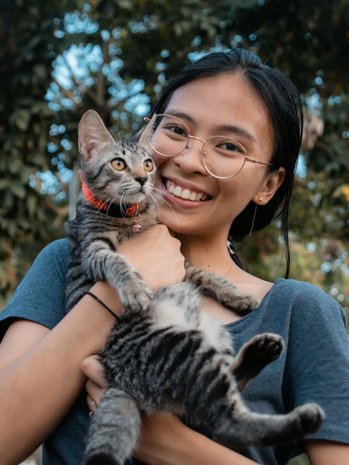 Mei Ling, head of cat care, holding a calm cat